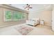 Spacious bedroom with large window, tray ceiling, ceiling fan and area rug at 13067 Overlook Pass, Roswell, GA 30075