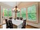 Bright dining room boasts hardwood floors, natural light, and access to the rear deck at 13067 Overlook Pass, Roswell, GA 30075