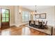 Formal dining room features hardwood floors, wainscoting, a chandelier, and natural light from large windows at 13067 Overlook Pass, Roswell, GA 30075