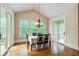 Bright dining room boasts hardwood floors, natural light, and a modern chandelier, perfect for entertaining at 13067 Overlook Pass, Roswell, GA 30075