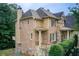 Charming home with a brick and stone facade, complemented by manicured landscaping at 13067 Overlook Pass, Roswell, GA 30075