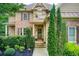 Inviting front entrance featuring a stone facade, complemented by lush greenery and manicured landscaping at 13067 Overlook Pass, Roswell, GA 30075
