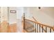 Upstairs hallway features hardwood floors, decorative railings, and ample natural light at 13067 Overlook Pass, Roswell, GA 30075