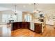 Spacious kitchen with island, stainless steel appliances, and hardwood floors overlooking living room at 13067 Overlook Pass, Roswell, GA 30075