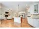 Open-concept kitchen features center island, stainless appliances, and hardwood floors at 13067 Overlook Pass, Roswell, GA 30075