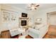 Bright living room with stone fireplace, built-in cabinets, and hardwood floors at 13067 Overlook Pass, Roswell, GA 30075
