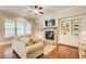 Comfortable living room with fireplace, large windows, and built-in shelving at 13067 Overlook Pass, Roswell, GA 30075
