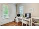 Bright office space with a white desk, chair, and ample natural light from the window and glass door at 13067 Overlook Pass, Roswell, GA 30075