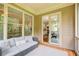 Cozy screened porch features a comfortable couch, offering seamless access to indoor living spaces at 13067 Overlook Pass, Roswell, GA 30075