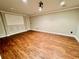 Basement with a decorative accent wall and wood floors at 2822 Salem Oak Way, Duluth, GA 30096
