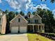 Attractive brick home with a two-car garage, covered porch, and professionally landscaped front yard at 2822 Salem Oak Way, Duluth, GA 30096
