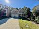 Inviting front exterior featuring a two-story brick facade and a spacious two-car garage at 2822 Salem Oak Way, Duluth, GA 30096