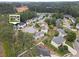 Aerial view of a home nestled in a residential area surrounded by trees and other houses at 565 Saint James Ct, Lawrenceville, GA 30044