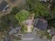 Aerial view of a property outlining lot lines showing a house with surrounding mature trees at 565 Saint James Ct, Lawrenceville, GA 30044