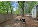 Backyard scene with a fire pit, swing set, and mature trees at 565 Saint James Ct, Lawrenceville, GA 30044