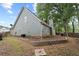 Back exterior of home shows a stone retaining wall and fencing at 565 Saint James Ct, Lawrenceville, GA 30044