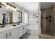 Well-lit bathroom featuring a double vanity, soaking tub, and glass-enclosed shower at 565 Saint James Ct, Lawrenceville, GA 30044