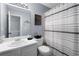 Classic bathroom featuring a vanity, toilet, and shower with a patterned curtain at 565 Saint James Ct, Lawrenceville, GA 30044