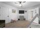 Bright bedroom featuring plush carpet, modern furniture, and a wall-mounted TV at 565 Saint James Ct, Lawrenceville, GA 30044