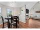 Open dining area with views of the living room and natural light from the window at 565 Saint James Ct, Lawrenceville, GA 30044