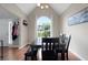 Bright dining room featuring vaulted ceilings, a large window, hardwood floors, and an open floor plan at 565 Saint James Ct, Lawrenceville, GA 30044