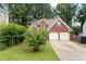 Two-story brick home with a two-car garage and a well-maintained front yard at 565 Saint James Ct, Lawrenceville, GA 30044