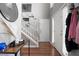 Welcoming foyer with hardwood floors, coat closet, decor, and staircase with white railings at 565 Saint James Ct, Lawrenceville, GA 30044