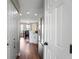 Bright hallway leading to the kitchen and dining area, featuring hardwood floors and ample storage at 565 Saint James Ct, Lawrenceville, GA 30044