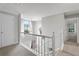 Open hallway featuring natural light and a clear view of the staircase at 565 Saint James Ct, Lawrenceville, GA 30044