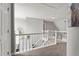 Hallway with carpet, white railings, and view of the lower level at 565 Saint James Ct, Lawrenceville, GA 30044