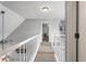 Bright hallway with white railings, neutral walls, and carpet, leading to bedrooms and living spaces at 565 Saint James Ct, Lawrenceville, GA 30044
