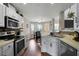 Bright kitchen with stainless steel appliances, ample counter space, and views to the dining room at 565 Saint James Ct, Lawrenceville, GA 30044