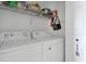Functional laundry room featuring modern appliances, storage shelves, and a clean, organized space at 565 Saint James Ct, Lawrenceville, GA 30044