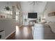 Spacious living room with a stone fireplace, modern decor, and views into the dining area at 565 Saint James Ct, Lawrenceville, GA 30044
