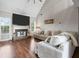 Bright living room featuring a fireplace, large windows, and a comfortable sectional sofa at 565 Saint James Ct, Lawrenceville, GA 30044