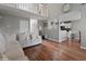 Open-concept living room with a sectional sofa, view of the kitchen, and staircase to the upper level at 565 Saint James Ct, Lawrenceville, GA 30044