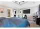 Serene main bedroom featuring a tray ceiling, en-suite bathroom, and a comfortable seating area at 565 Saint James Ct, Lawrenceville, GA 30044