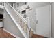 Inviting staircase with white railings, wood flooring, and decorative wall art at 565 Saint James Ct, Lawrenceville, GA 30044