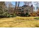 Expansive backyard featuring lush greenery, mature trees, and the home's rear facade at 656 Gunby Se Rd, Marietta, GA 30067