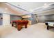 Finished basement featuring a billiard table, kitchenette, and neutral carpet at 656 Gunby Se Rd, Marietta, GA 30067