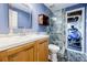 Bathroom featuring tiled shower, modern sink, and cabinet, with a clear view into an adjacent room at 656 Gunby Se Rd, Marietta, GA 30067