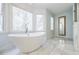 Bright bathroom with a sleek soaking tub, natural light, and elegant design at 656 Gunby Se Rd, Marietta, GA 30067