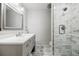 Bright bathroom featuring a marble shower, vanity with double sinks and plenty of storage space at 656 Gunby Se Rd, Marietta, GA 30067