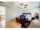 Bright bedroom with hardwood floors, ceiling fan, and a view to the bathroom at 656 Gunby Se Rd, Marietta, GA 30067