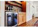 Close up of the drink station featuring a stone backsplash, sink, and wine fridge at 656 Gunby Se Rd, Marietta, GA 30067