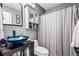 Cozy bathroom featuring a custom glass vessel sink and a decorative shower curtain at 1543 Blossom Dr, Atlanta, GA 30349