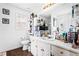 Bright bathroom featuring modern fixtures, a large mirror, and wood-look flooring at 1543 Blossom Dr, Atlanta, GA 30349