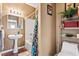 Bathroom featuring a pedestal sink, tub with shower, and decorative storage shelving at 1543 Blossom Dr, Atlanta, GA 30349