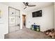 Bright bedroom with a mirrored closet, ceiling fan, carpet floors, and a television at 1543 Blossom Dr, Atlanta, GA 30349