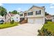 Two-story home with a well-maintained lawn, driveway, and a two-car garage in a suburban neighborhood at 1543 Blossom Dr, Atlanta, GA 30349